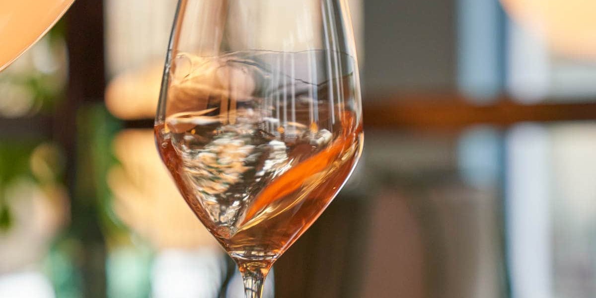 A glass of wine being swirled to activate the aromas.