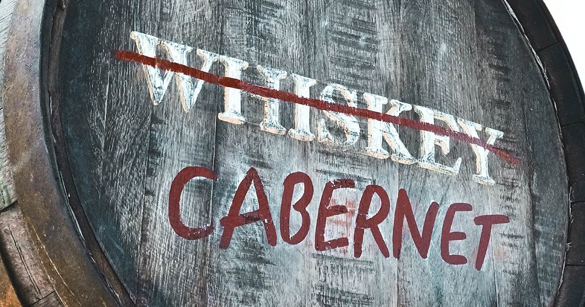 An oak barrel with 'whiskey' crossed off and Cabernet written in.
